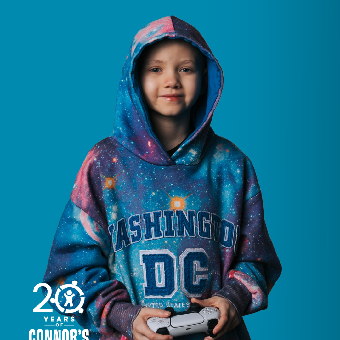 kid wearing a hoodie and holding a video game controler